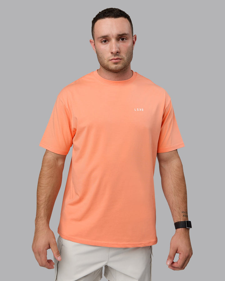 Man wearing Unisex 1% Better Value Series FLXCotton Tee Oversize - Mellow Peach-White
