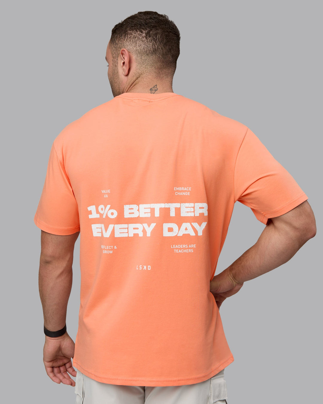 Man wearing Unisex 1% Better Value Series FLXCotton Tee Oversize - Mellow Peach-White