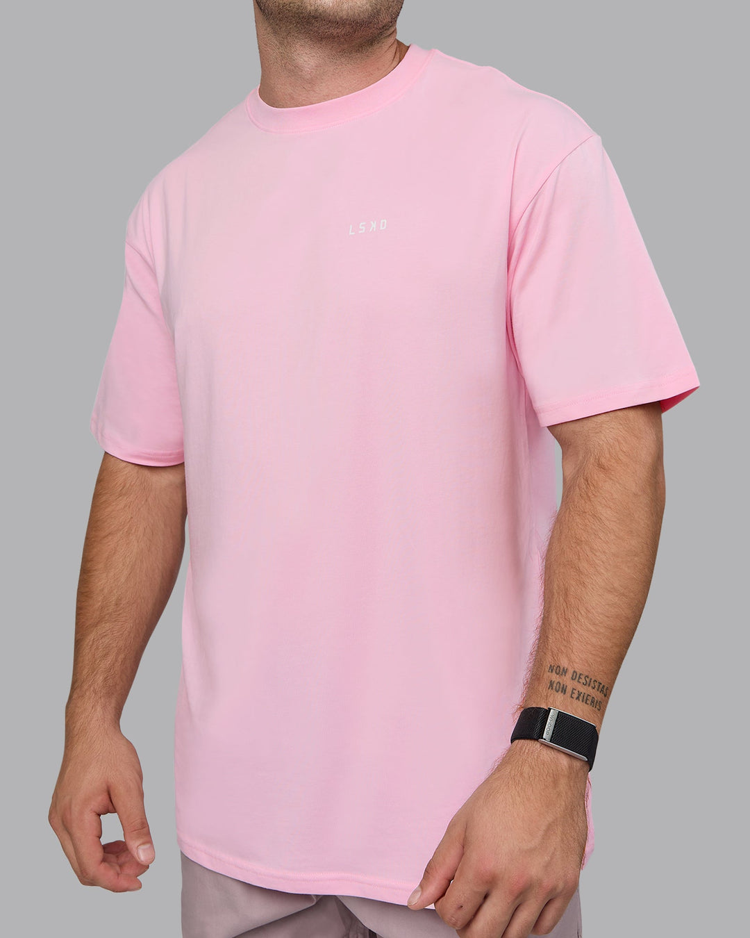 Man wearing Unisex 1% Better Value Series FLXCotton Tee Oversize - Pale Pink-White