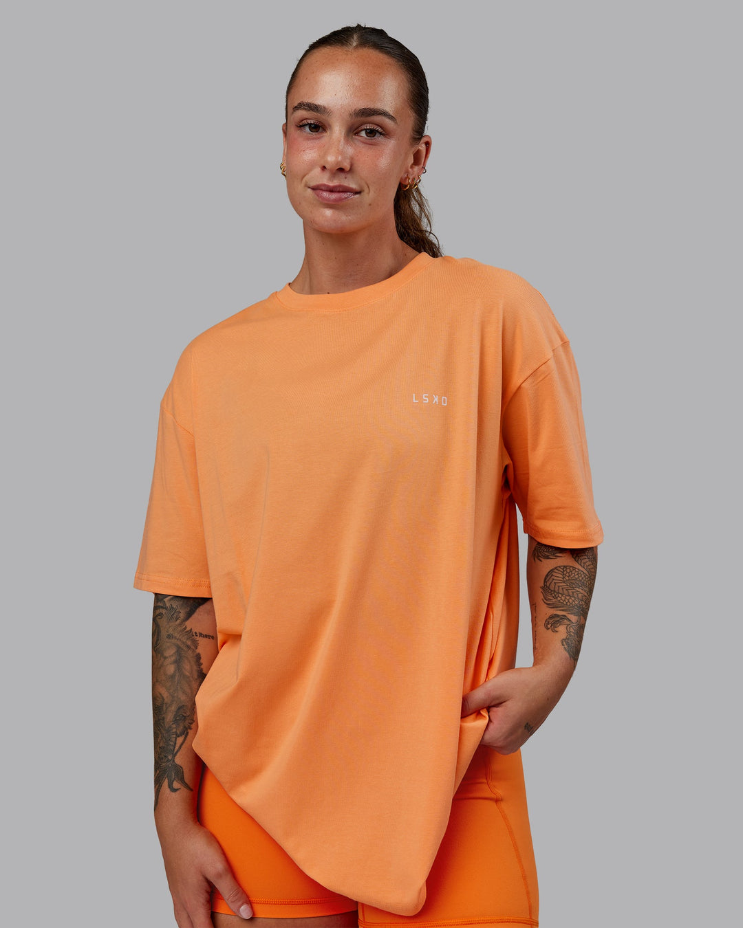 Woman wearing Unisex 1% Better Value Series FLXCotton Tee Oversize - Sorbet-Festival Bloom