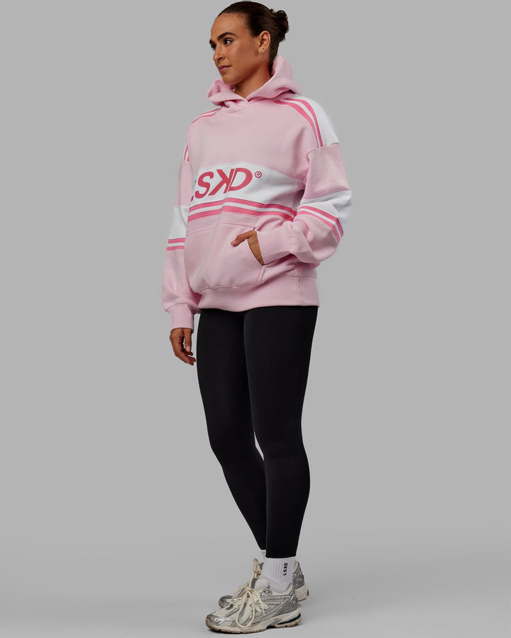 Woman wearing Unisex A-Team Hoodie Oversize - Petal Pink-White