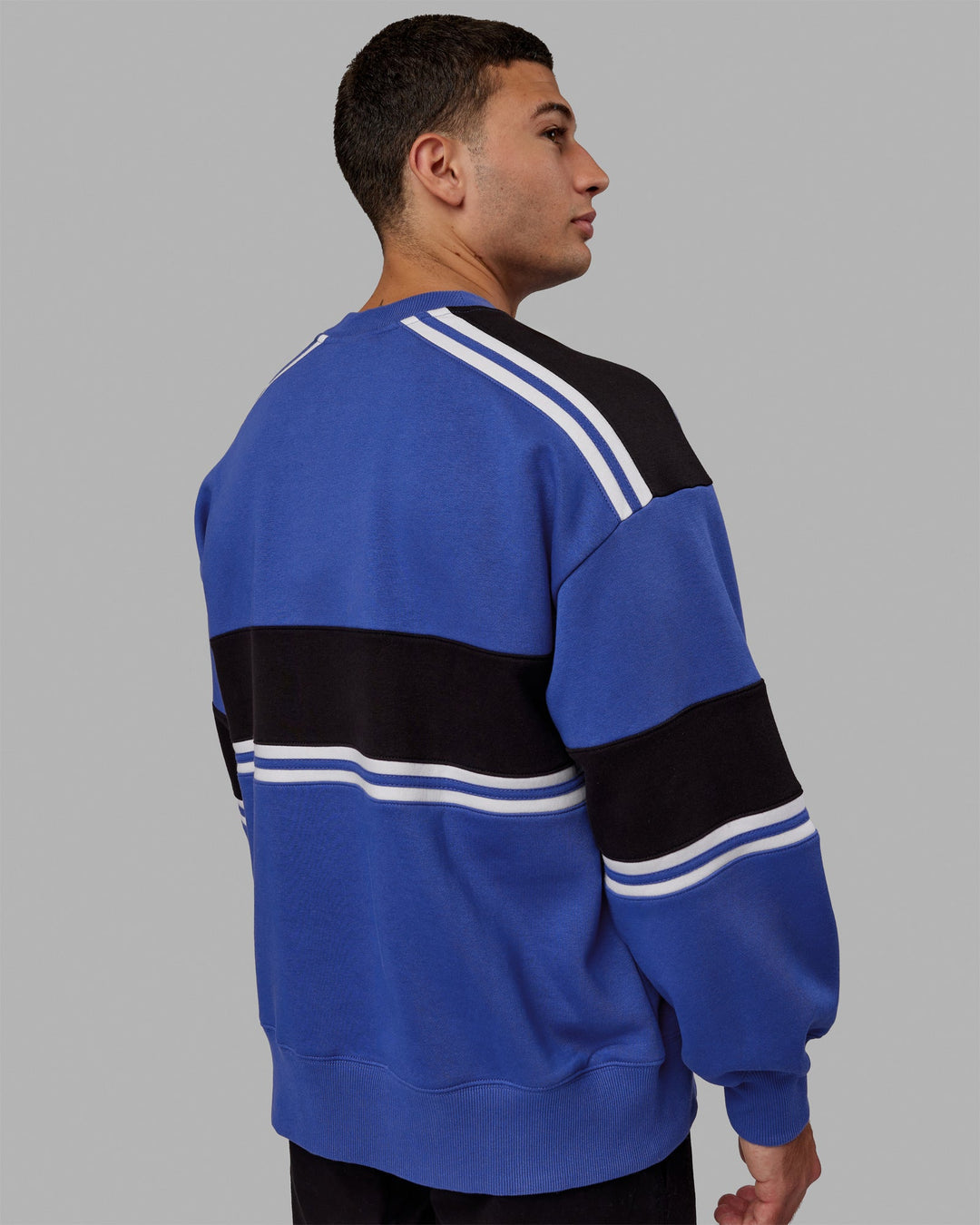 Man wearing Unisex A-Team Sweater Oversize - Power Cobalt-Black