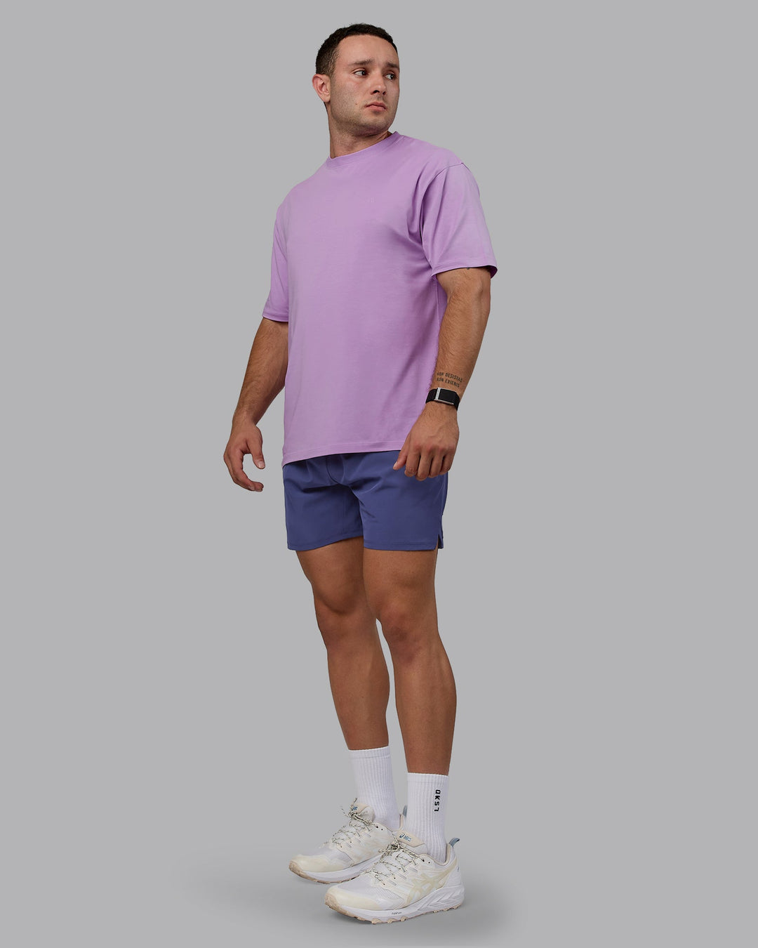 Man wearing Unisex Deluxe PimaFLX Tee Oversize - Light Violet