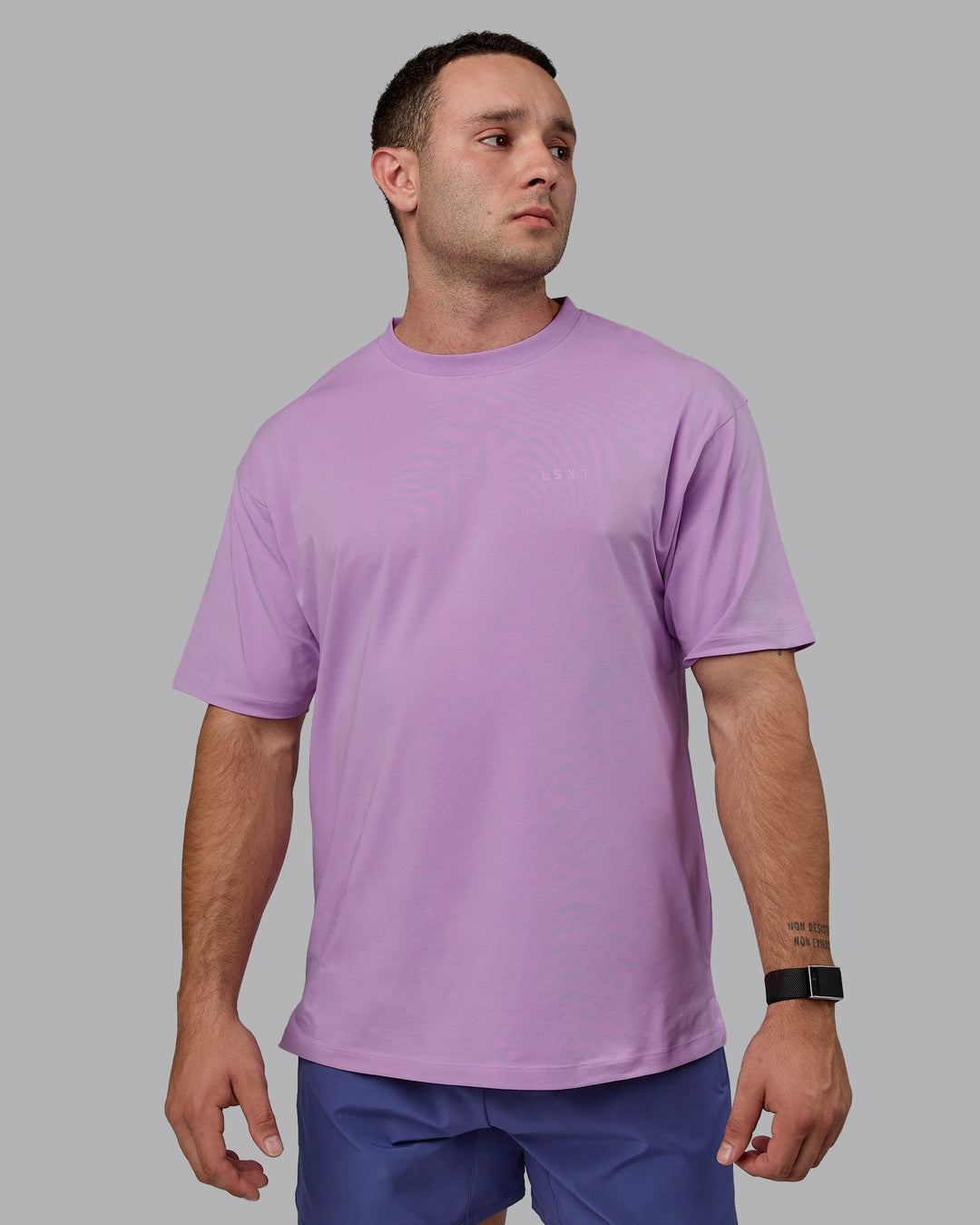 Man wearing Unisex Deluxe PimaFLX Tee Oversize - Light Violet