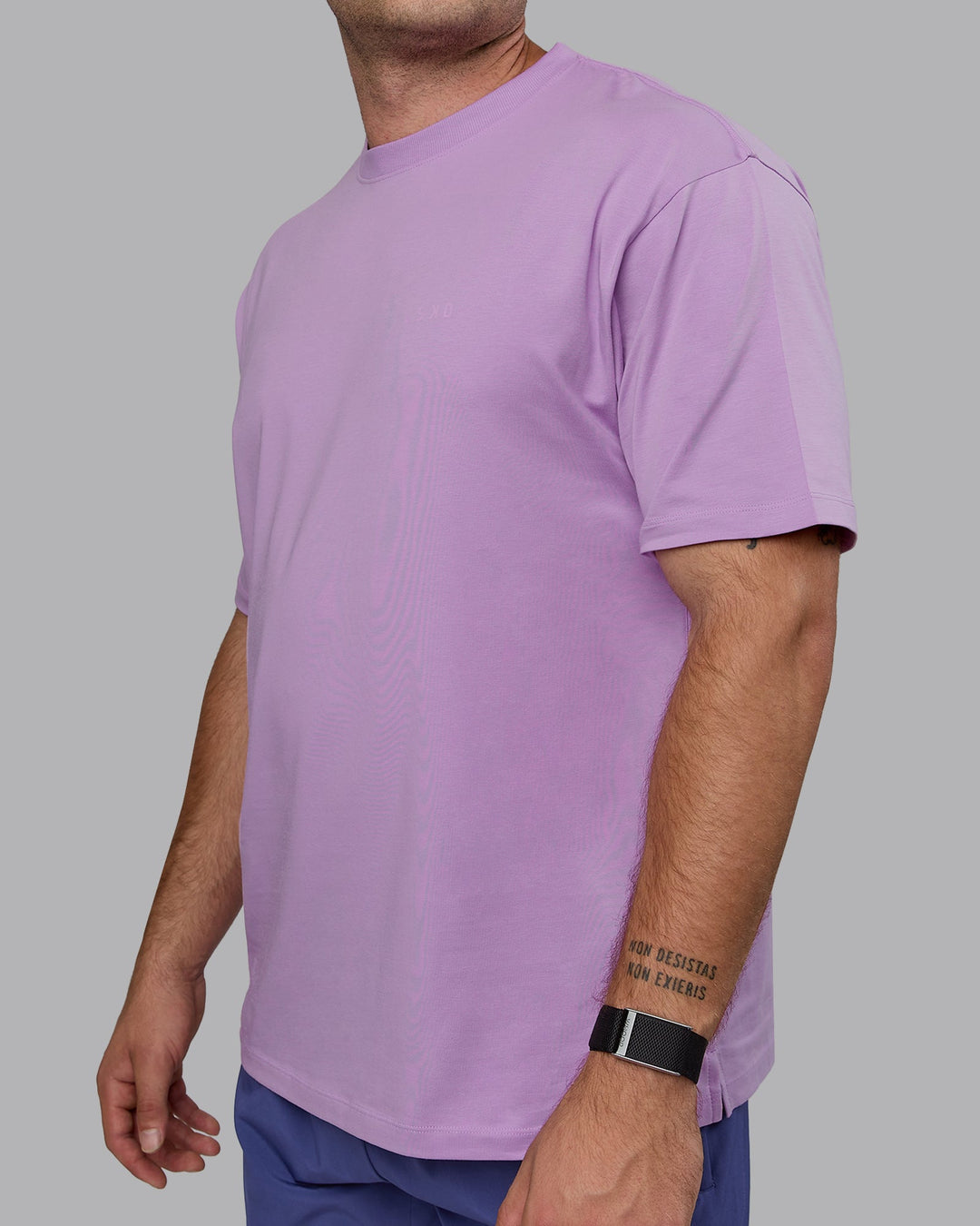 Man wearing Unisex Deluxe PimaFLX Tee Oversize - Light Violet