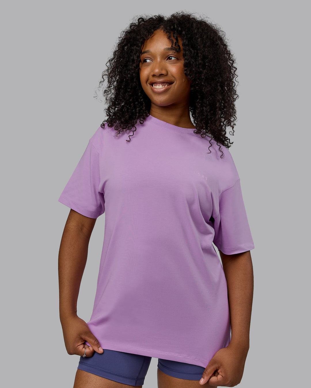 Woman wearing Unisex Deluxe PimaFLX Tee Oversize - Light Violet