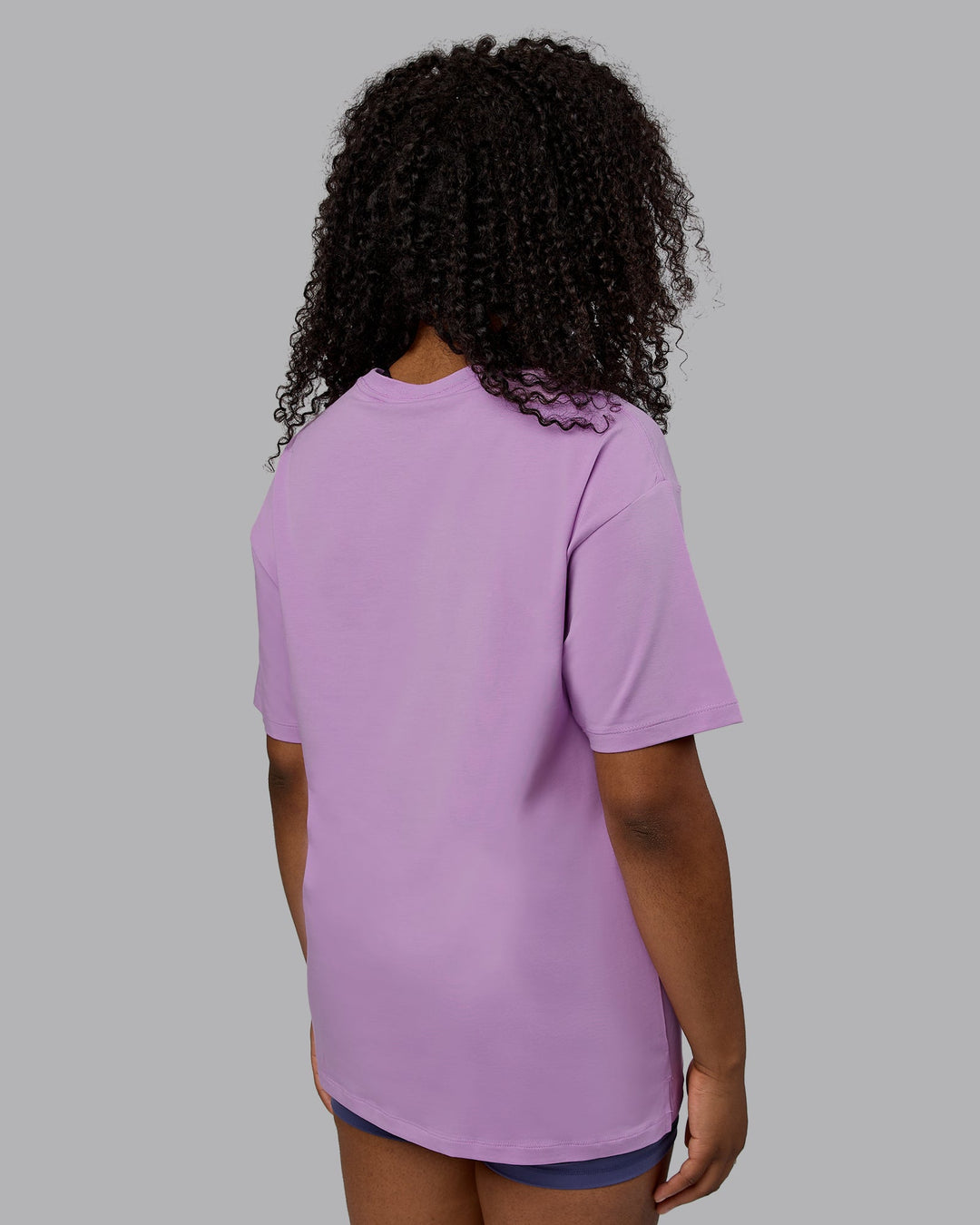 Woman wearing Unisex Deluxe PimaFLX Tee Oversize - Light Violet