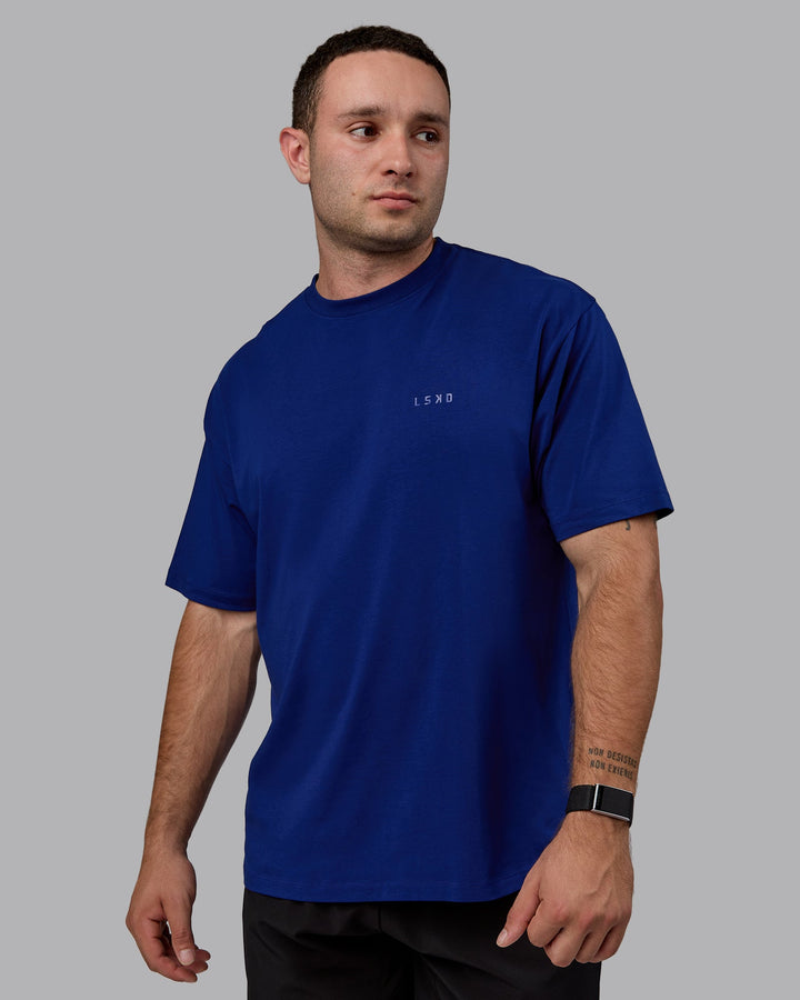 Man wearing Unisex Deluxe PimaFLX Tee Oversize - Midnight Blue
