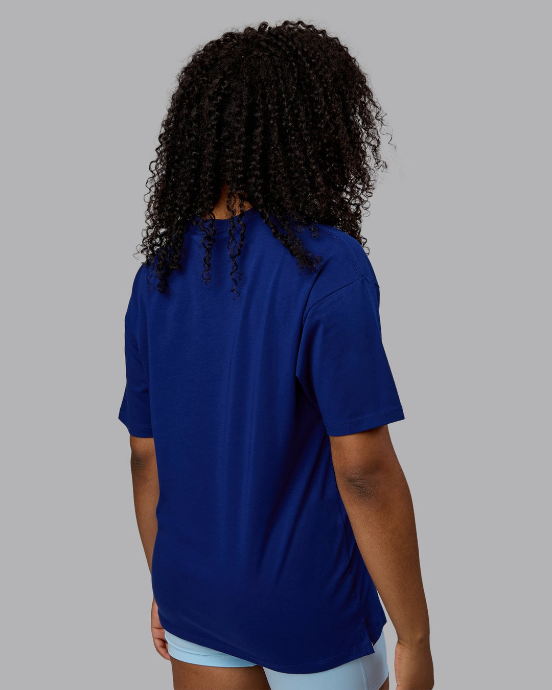 Woman wearing Unisex Deluxe PimaFLX Tee Oversize - Midnight Blue