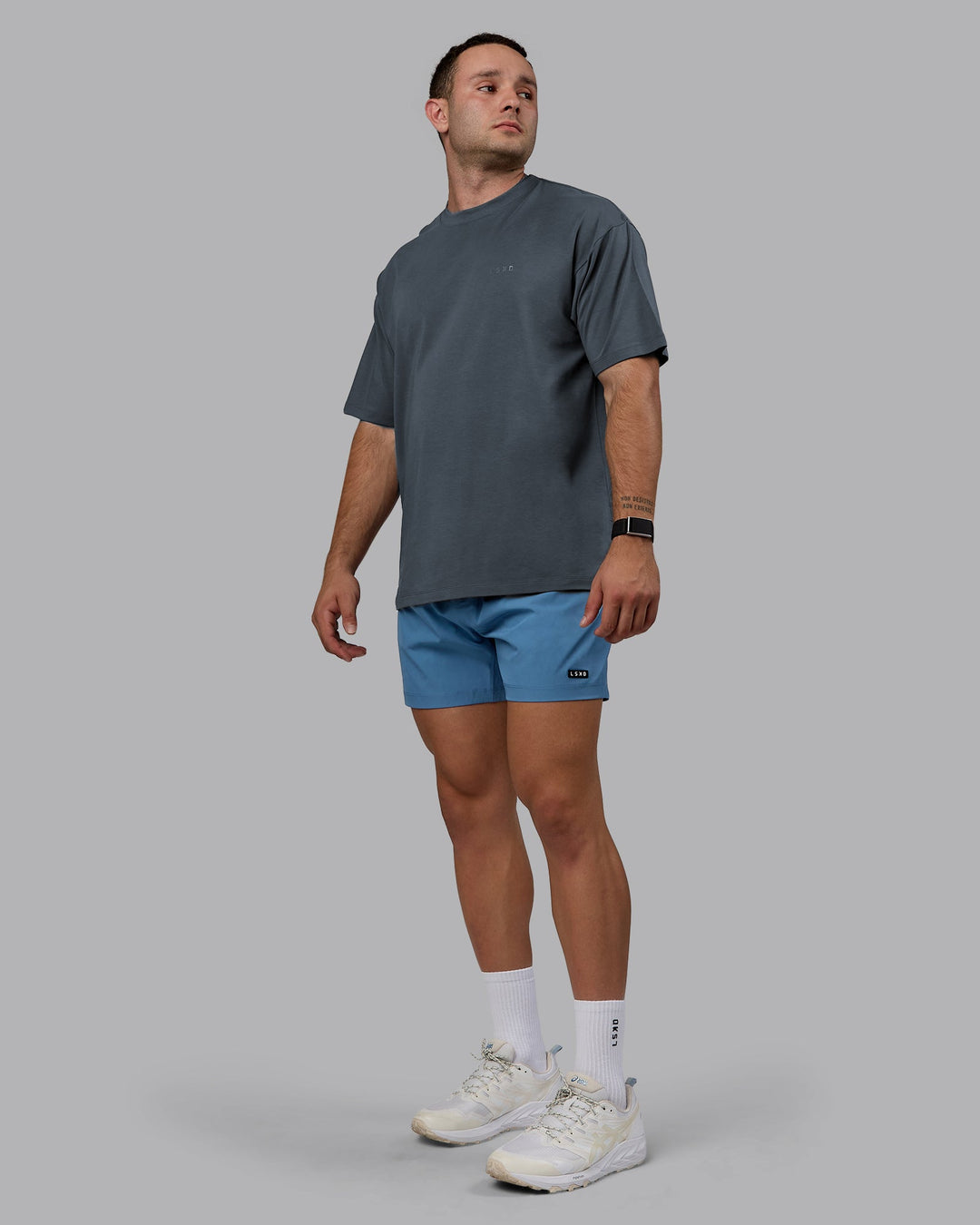 Man wearing Unisex Deluxe PimaFLX Tee Oversize - Turbulence