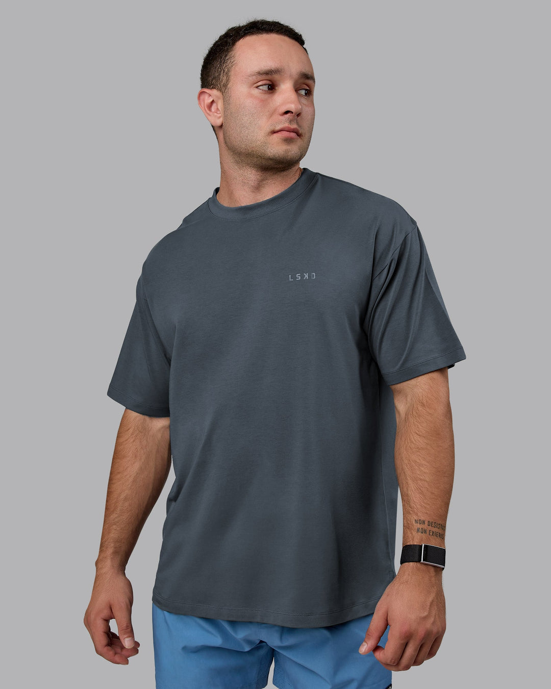 Man wearing Unisex Deluxe PimaFLX Tee Oversize - Turbulence