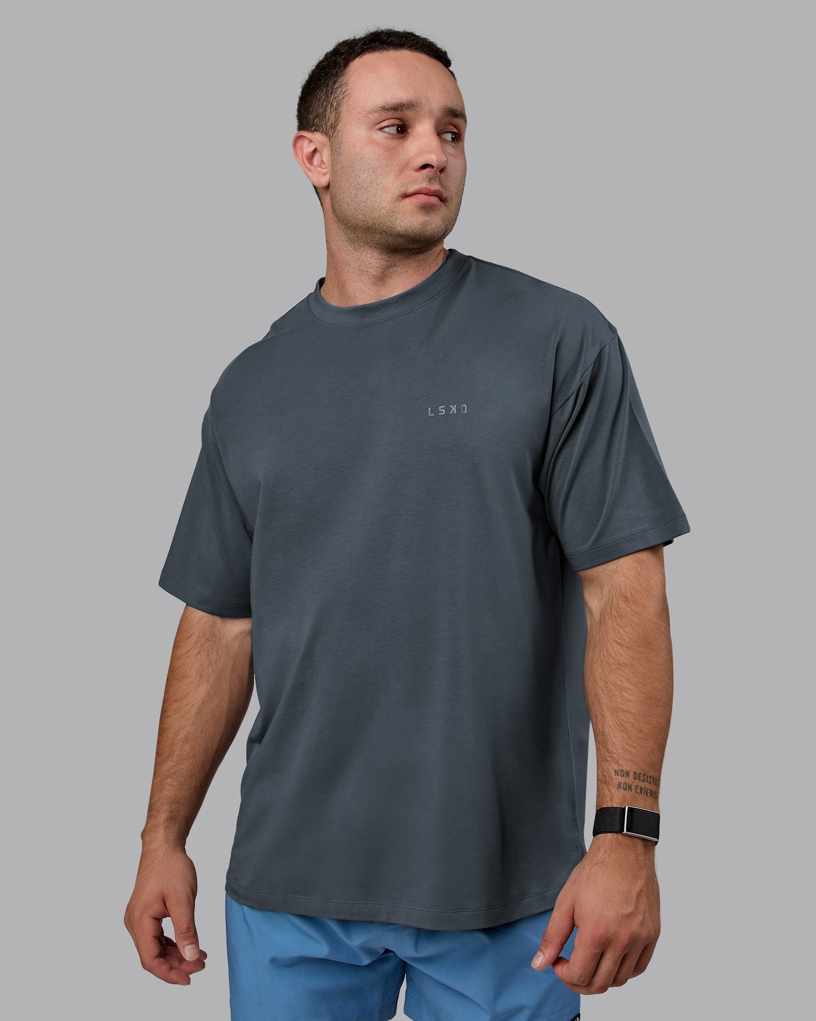 Man wearing Unisex Deluxe PimaFLX Tee Oversize - Turbulence