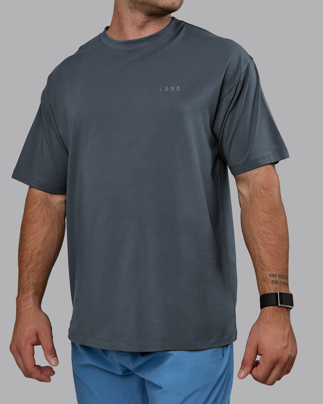Man wearing Unisex Deluxe PimaFLX Tee Oversize - Turbulence