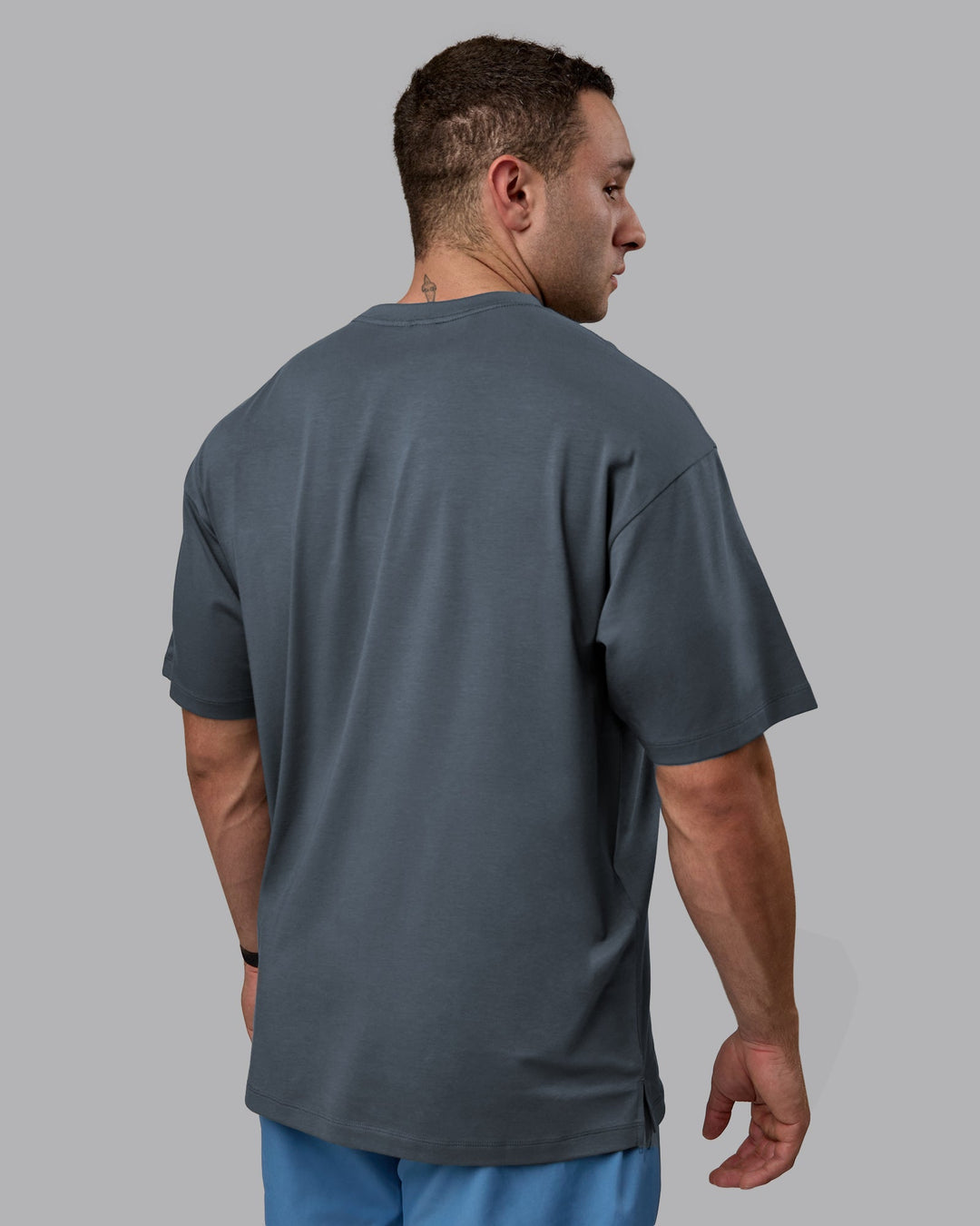 Man wearing Unisex Deluxe PimaFLX Tee Oversize - Turbulence
