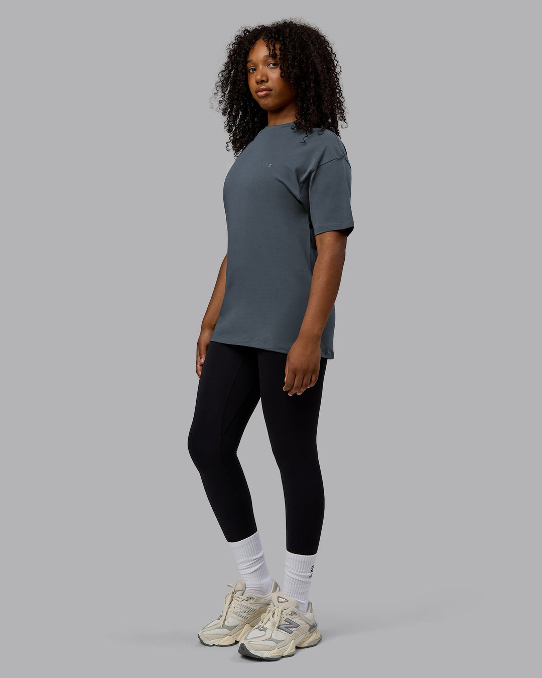 Woman wearing Unisex Deluxe PimaFLX Tee Oversize - Turbulence