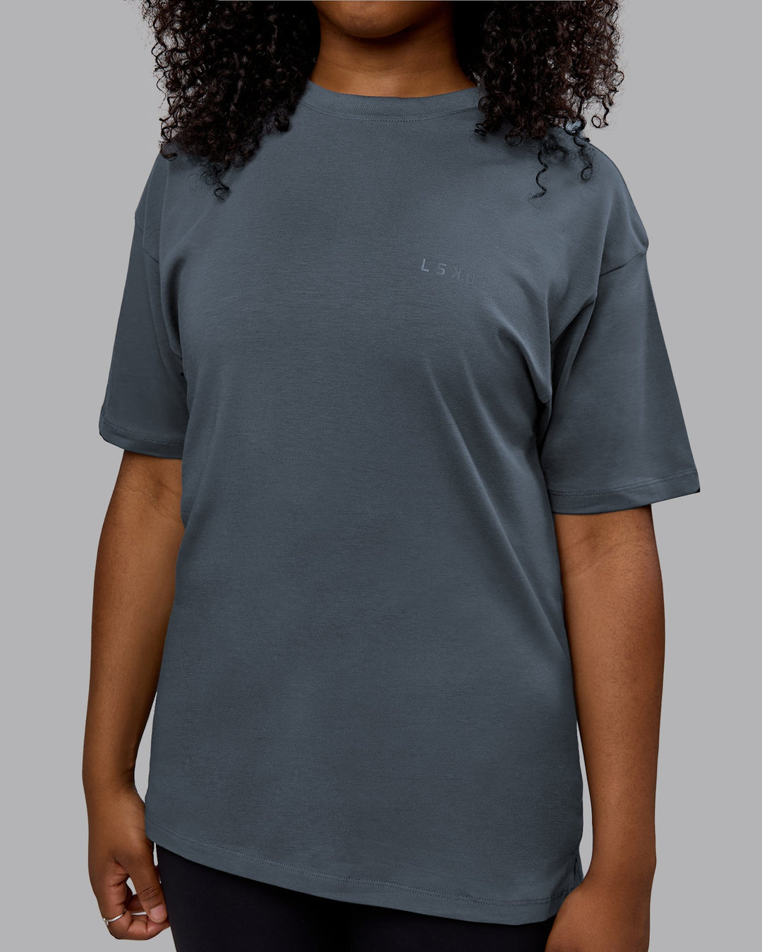 Woman wearing Unisex Deluxe PimaFLX Tee Oversize - Turbulence