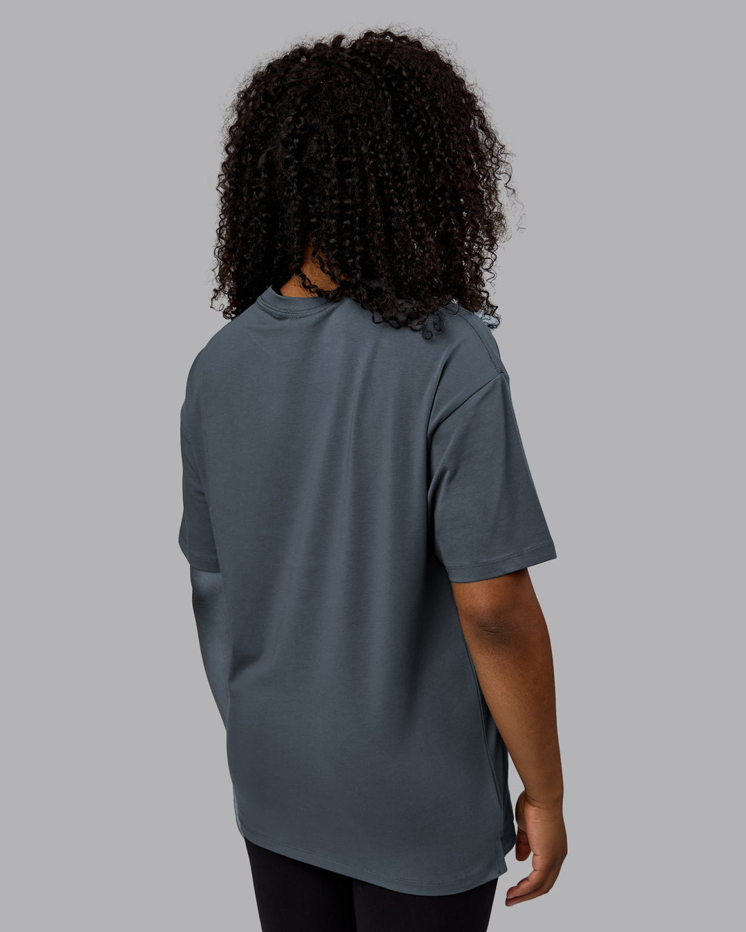 Woman wearing Unisex Deluxe PimaFLX Tee Oversize - Turbulence