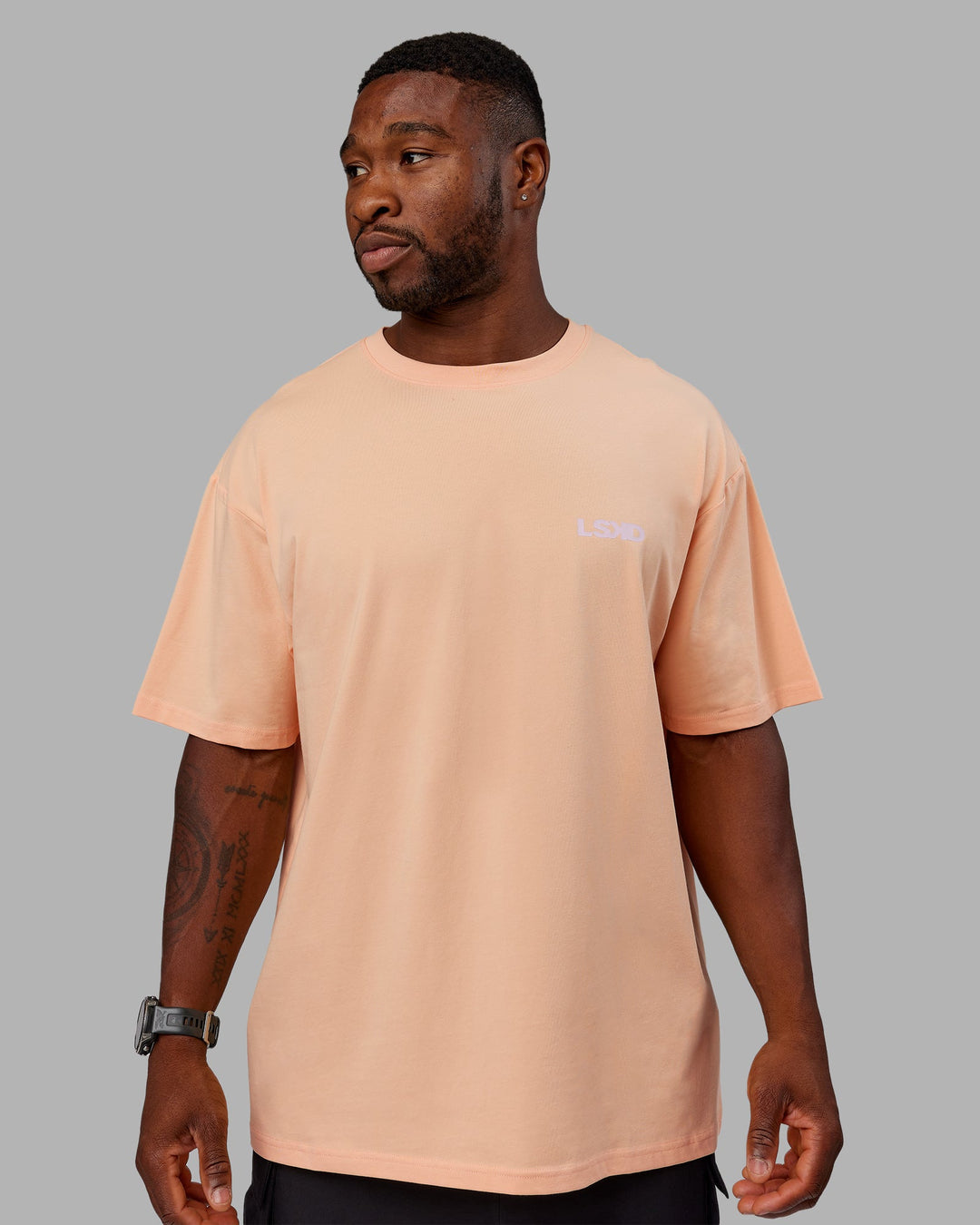 Man wearing Unisex E.T.J FLXCotton Tee Oversize - Peach Fuzz-Purple