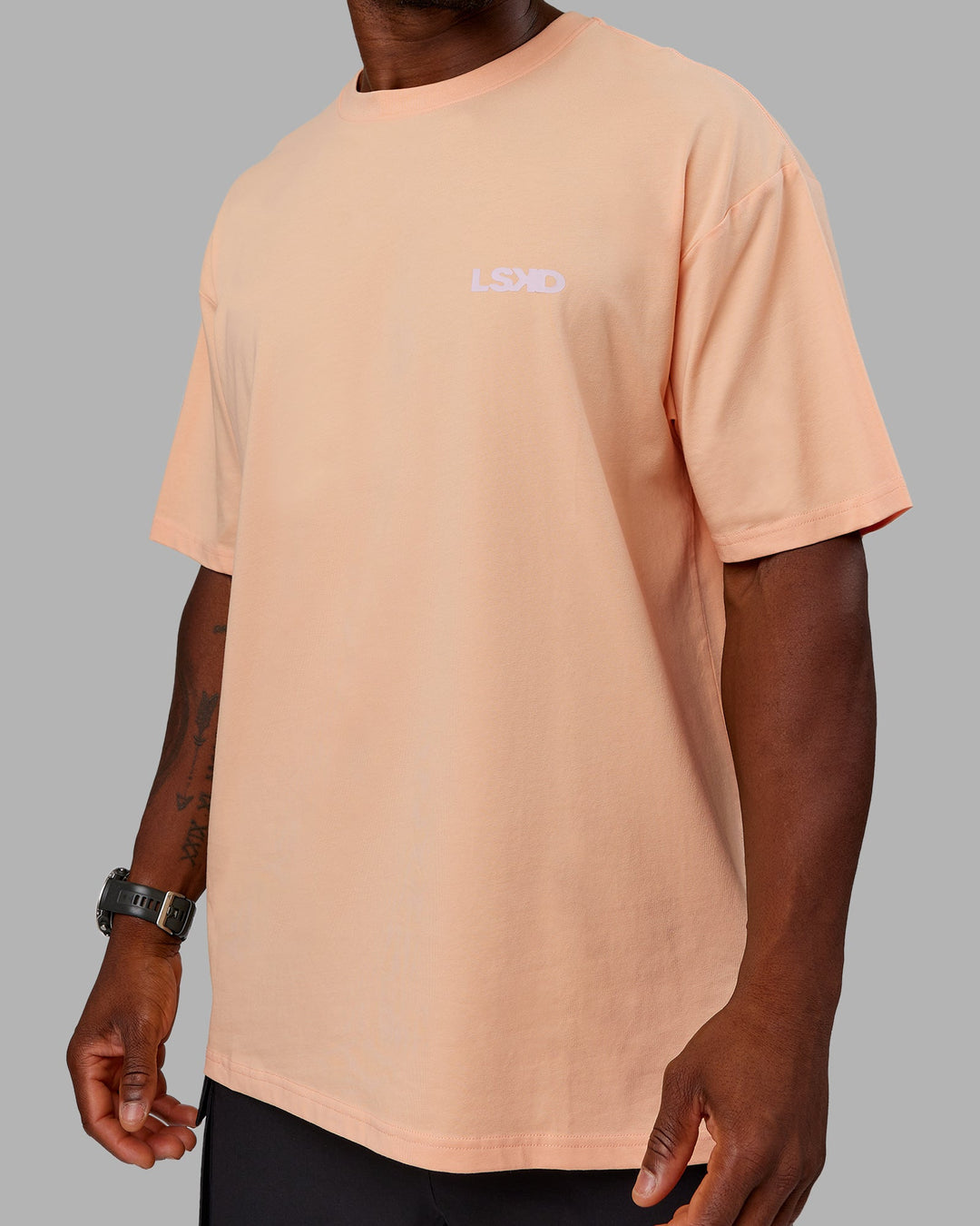 Man wearing Unisex E.T.J FLXCotton Tee Oversize - Peach Fuzz-Purple