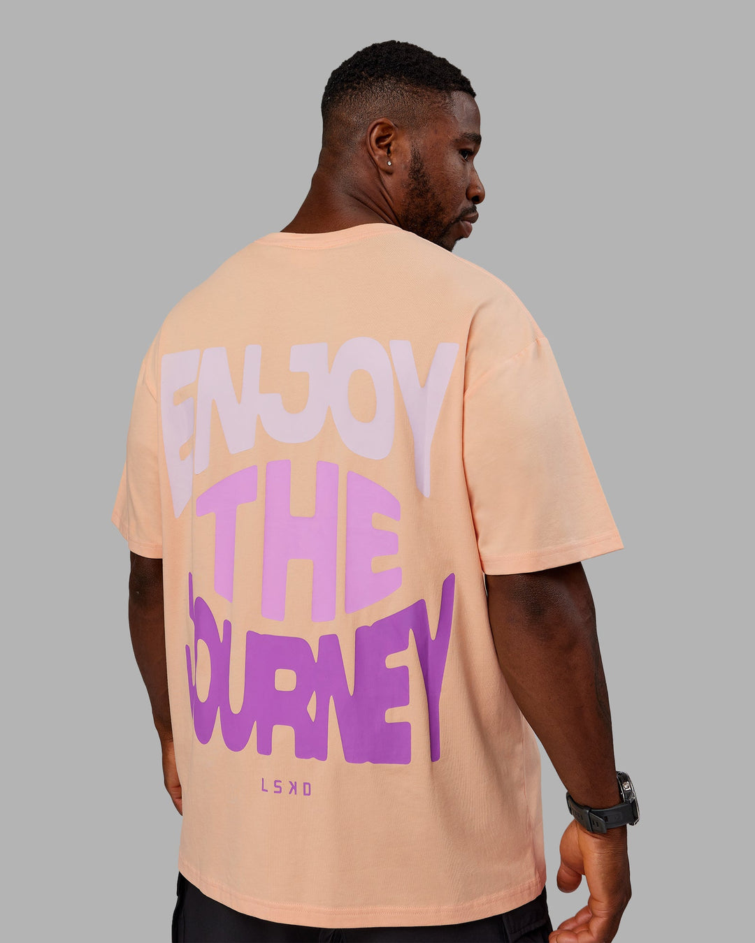 Man wearing Unisex E.T.J FLXCotton Tee Oversize - Peach Fuzz-Purple