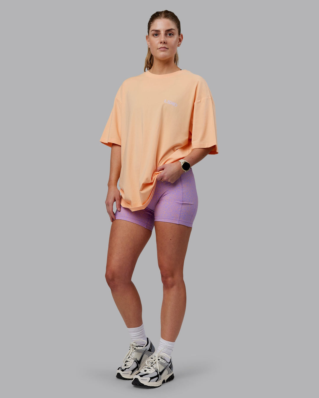 Woman wearing Unisex E.T.J FLXCotton Tee Oversize - Peach Fuzz-Purple