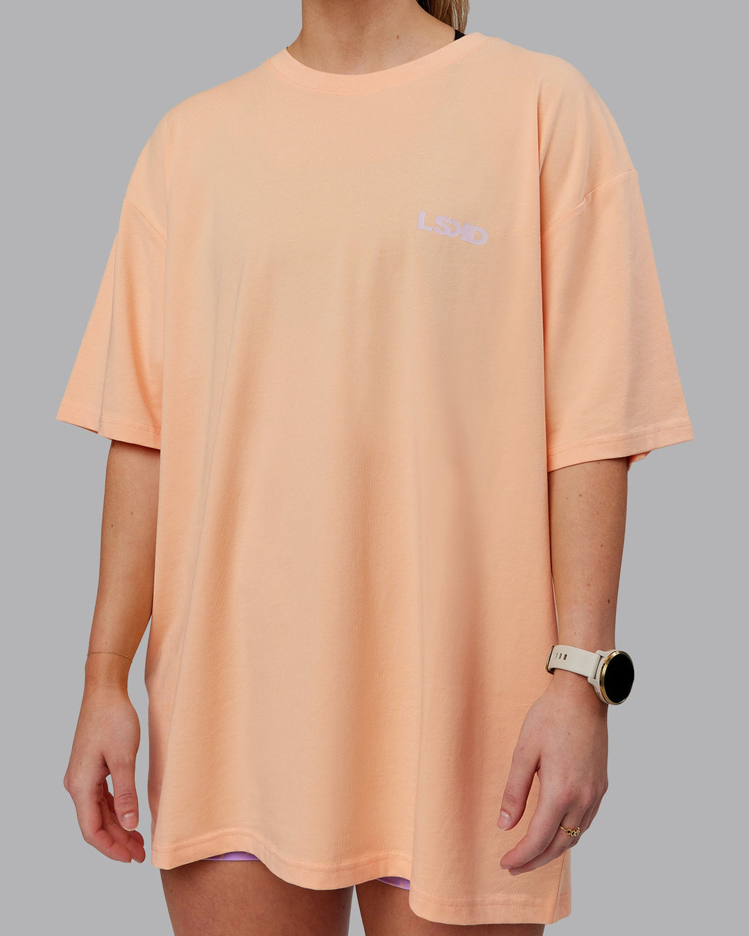 Woman wearing Unisex E.T.J FLXCotton Tee Oversize - Peach Fuzz-Purple