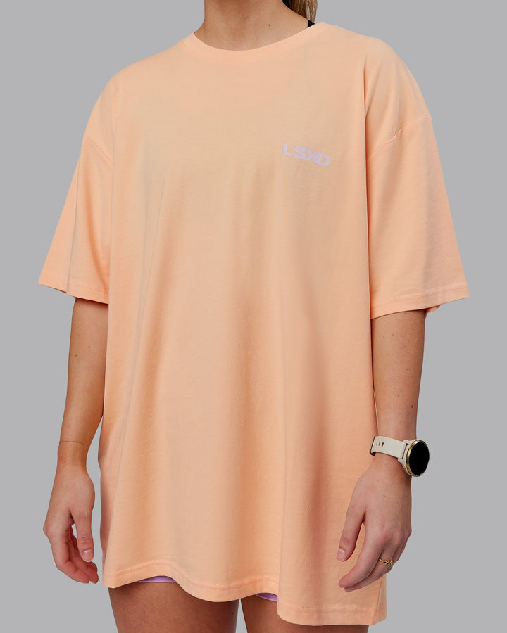 Woman wearing Unisex E.T.J FLXCotton Tee Oversize - Peach Fuzz-Purple
