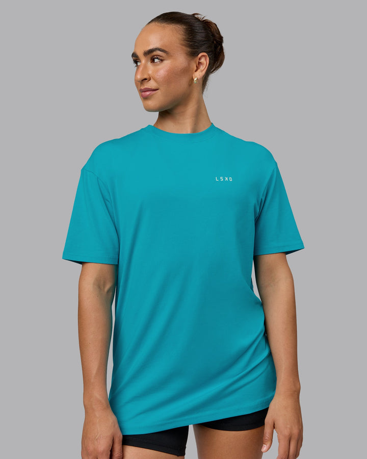 Woman wearing Unisex Enjoy the Journey Value Series FLXCotton Tee Oversize - Bluebird-Surf Spray
