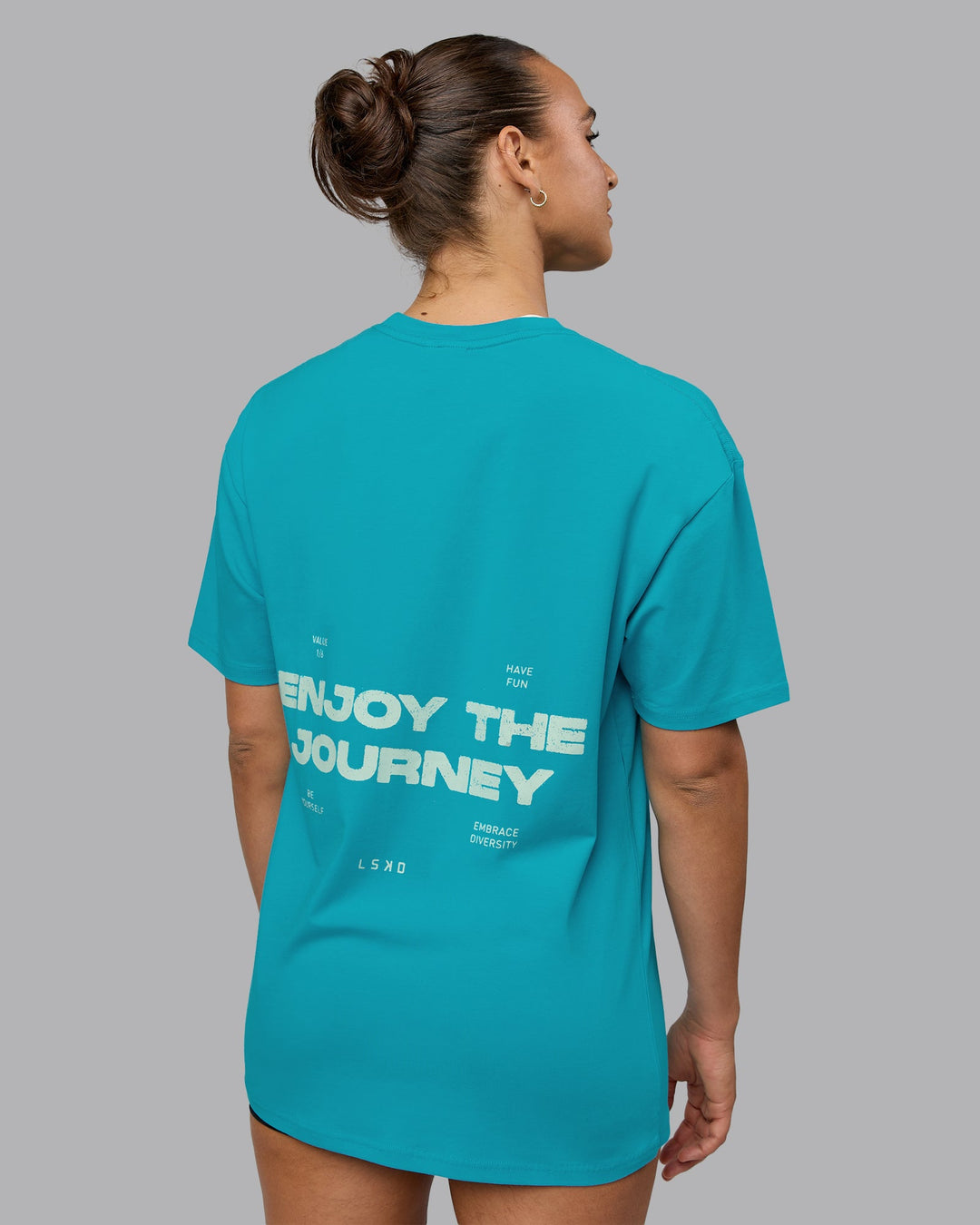 Woman wearing Unisex Enjoy the Journey Value Series FLXCotton Tee Oversize - Bluebird-Surf Spray