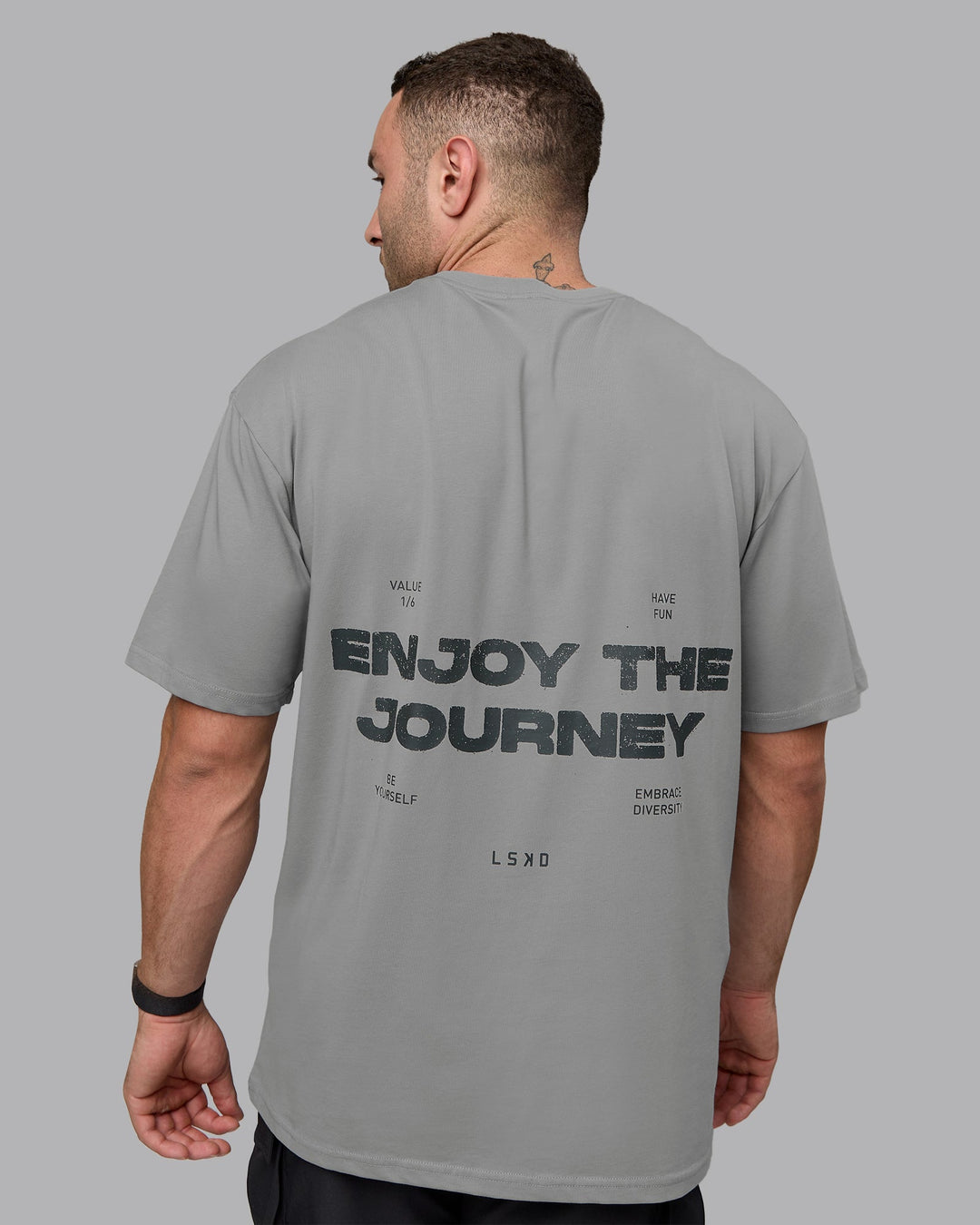 Man wearing Unisex Enjoy the Journey Value Series FLXCotton Tee Oversize - Circular Grey-Pirate Black