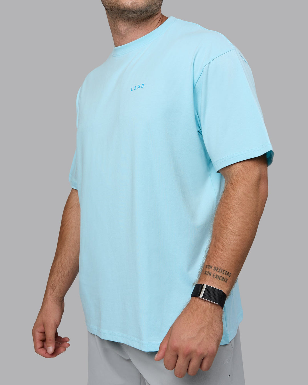 Man wearing Unisex Enjoy the Journey Value Series FLXCotton Tee Oversize - Crystal Blue-Bay Blue