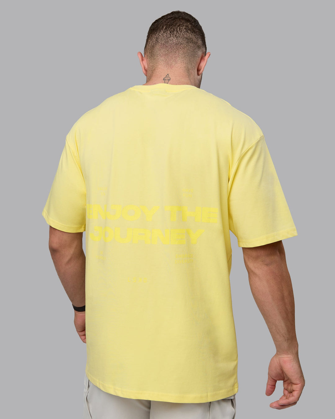 Man wearing Unisex Enjoy the Journey Value Series FLXCotton Tee Oversize - Pale Yellow-Sundress