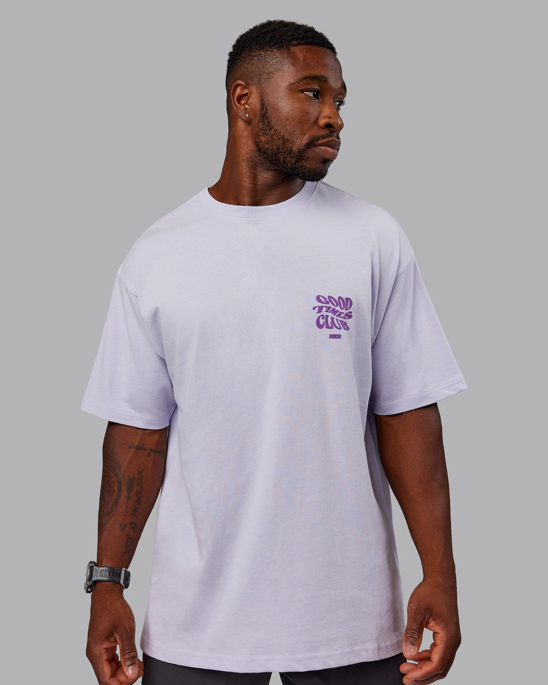 Man wearing Unisex Good Times Heavyweight Tee Oversize - Purple Heather-Purple Swirl