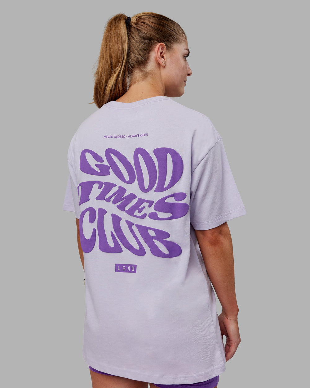 Woman wearing Unisex Good Times Heavyweight Tee Oversize - Purple Heather-Purple Swirl