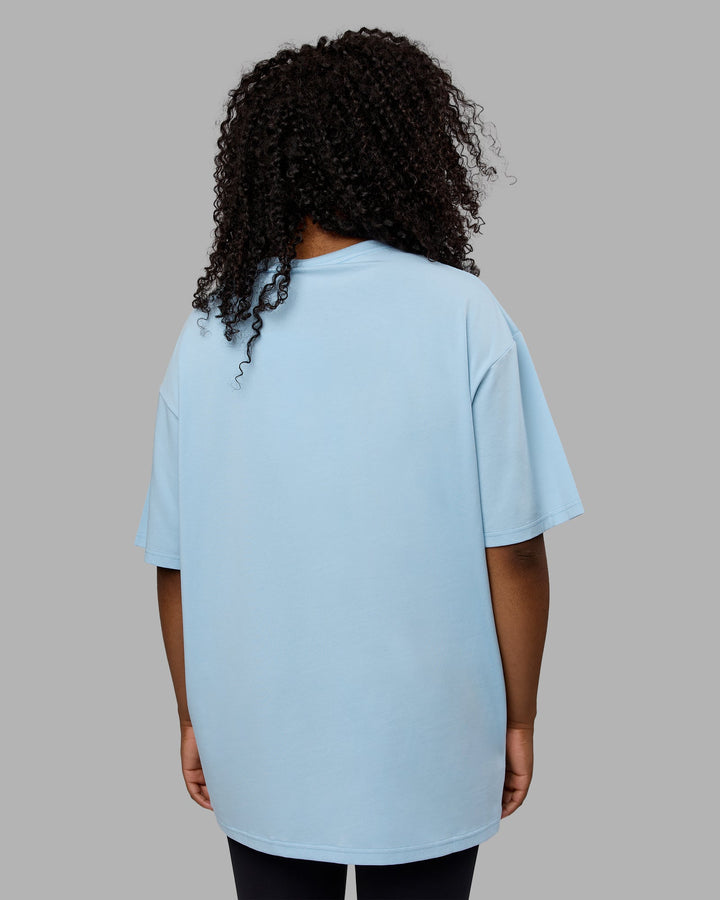 Woman wearing Unisex Just Keep Running FLXCotton Tee Oversize - Glacial Blue-Off White
