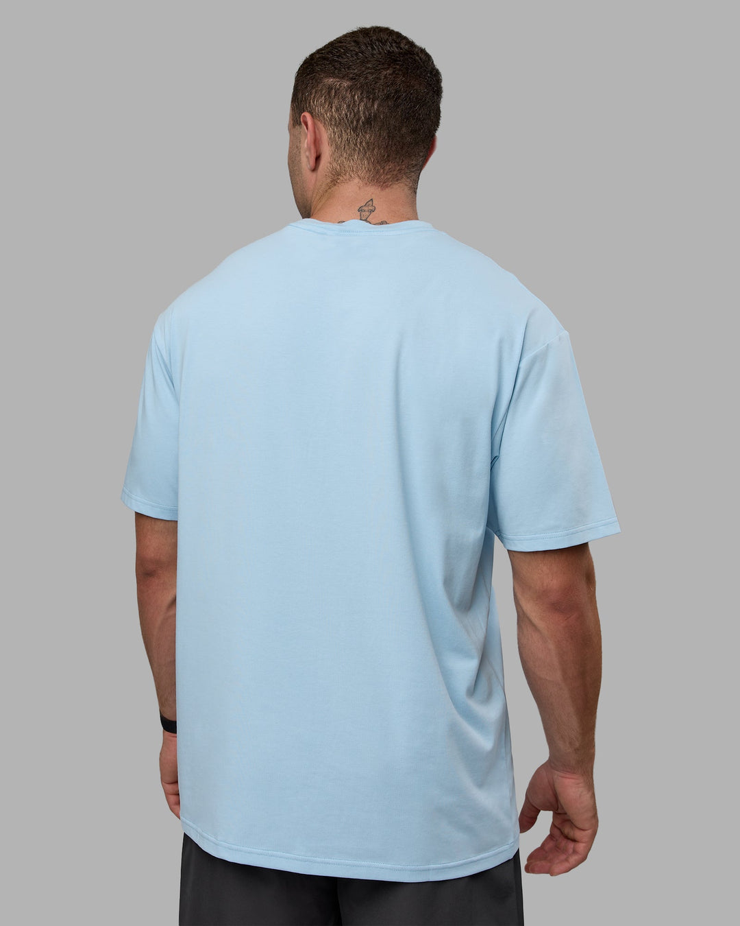 Man wearing Unisex Just Keep Running FLXCotton Tee Oversize - Glacial Blue-Off White