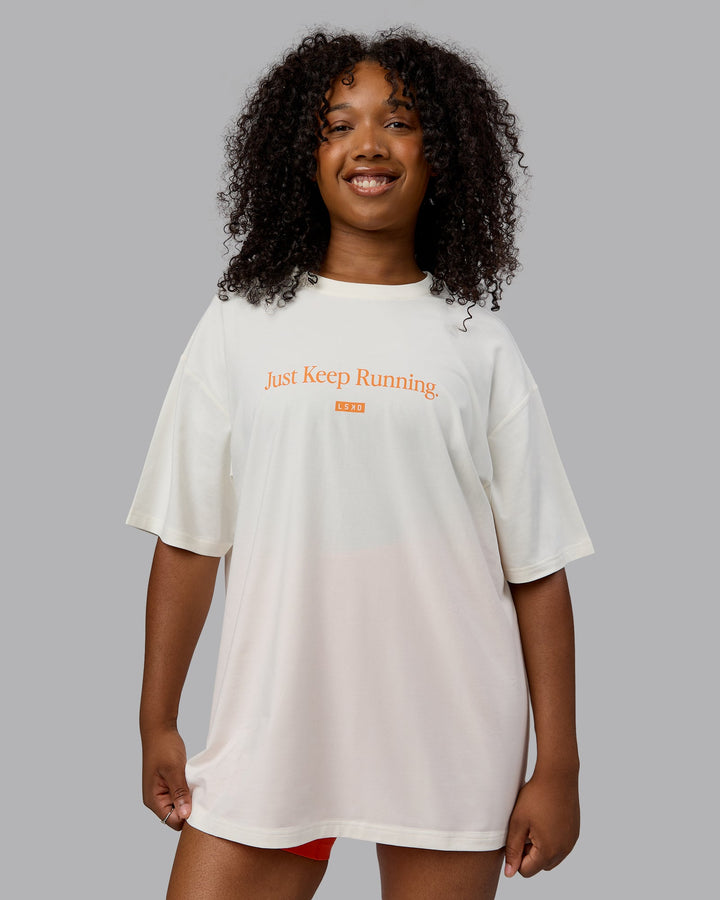 Woman wearing Unisex Just Keep Running FLXCotton Tee Oversize - Off White-Vibrant Orange
