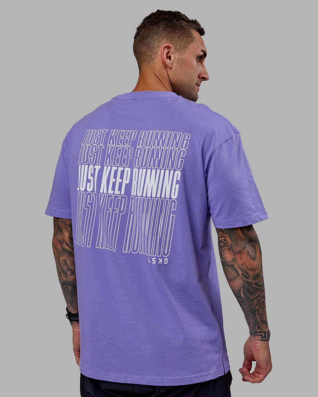 Man wearing Unisex Keep On Running FLXCotton Tee Oversize - Dahlia Purple