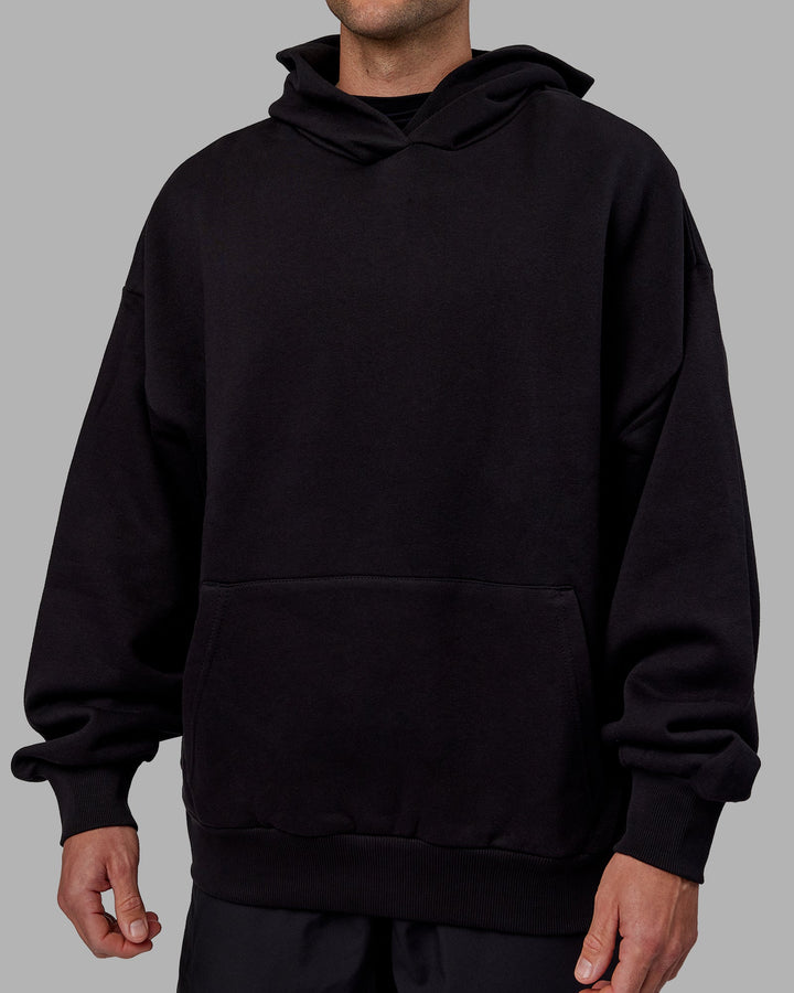 Man wearing Unisex Keep on Running Hoodie Oversize - Black-White
