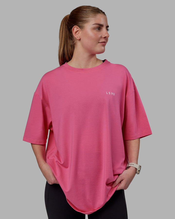 Woman wearing Unisex Lift-Up FLXCotton Tee Oversize - Carmine Rose-White
