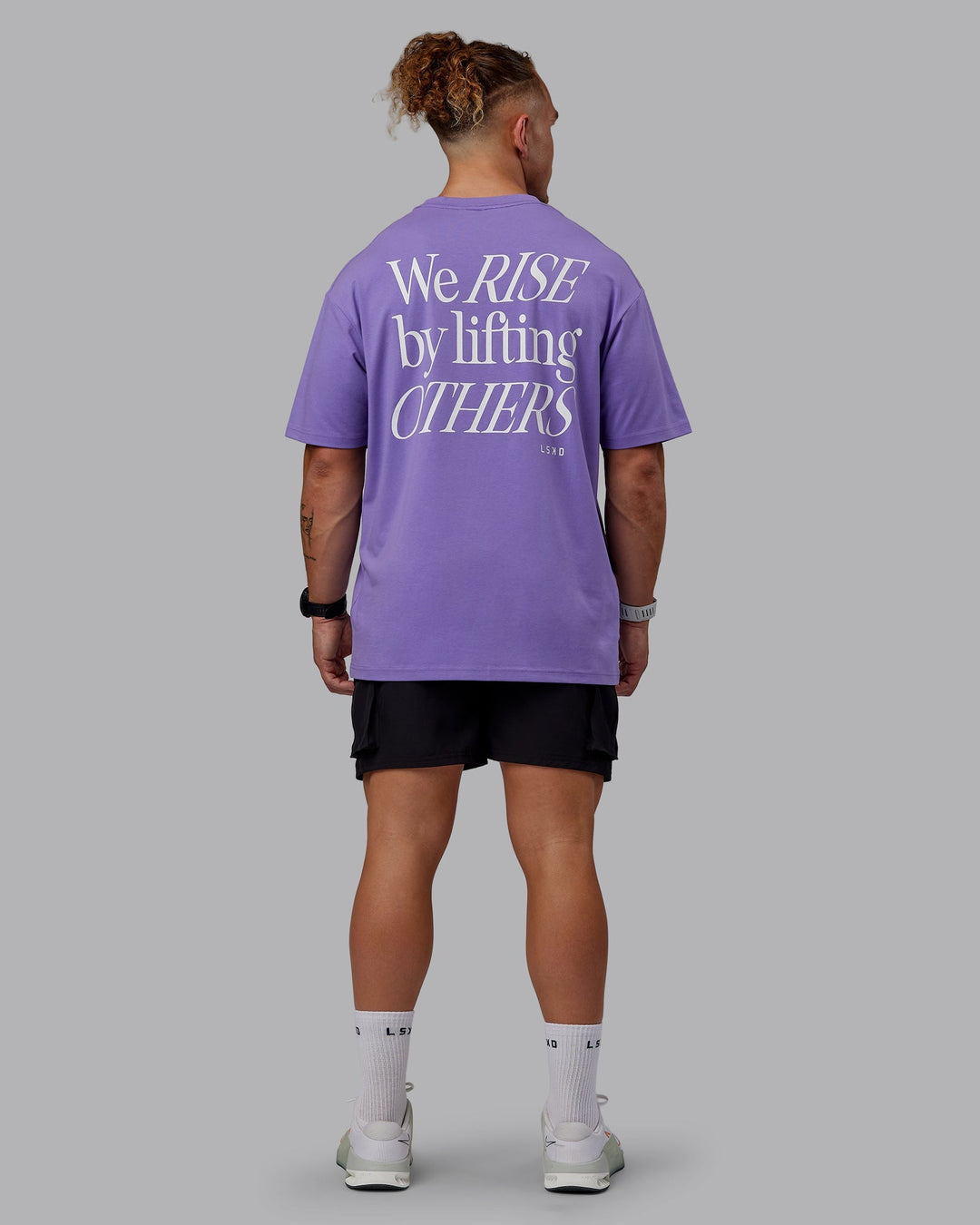 Man wearing Unisex Lift-Up FLXCotton Tee Oversize - Dahlia Purple