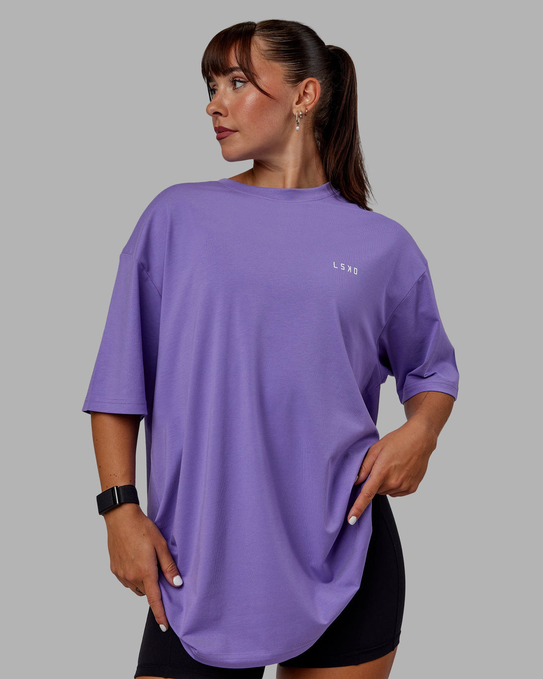 Woman wearing Unisex Lift-Up FLXCotton Tee Oversize - Dahlia Purple