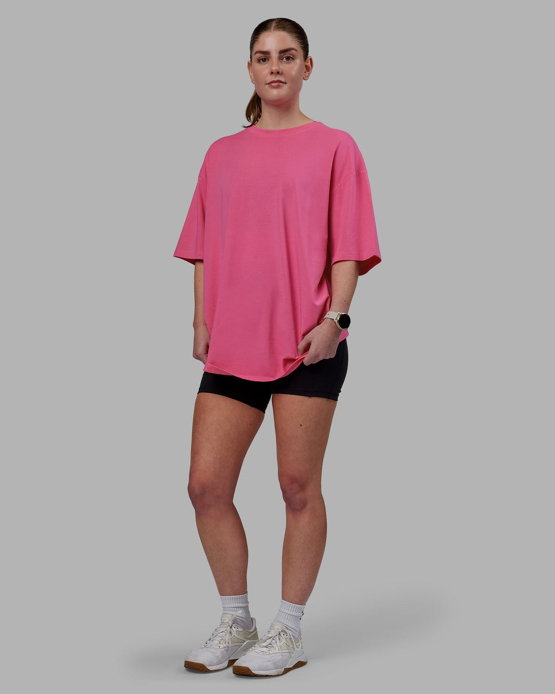 Woman wearing Unisex Lifting Club FLXCotton Tee Oversize - Carmine Rose-White