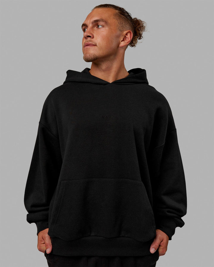 Man wearing Unisex MVP Hoodie Oversize - Black
