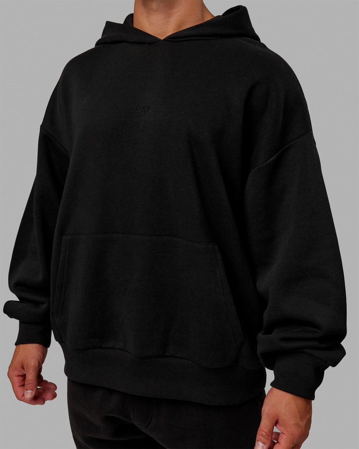 Man wearing Unisex MVP Hoodie Oversize - Black
