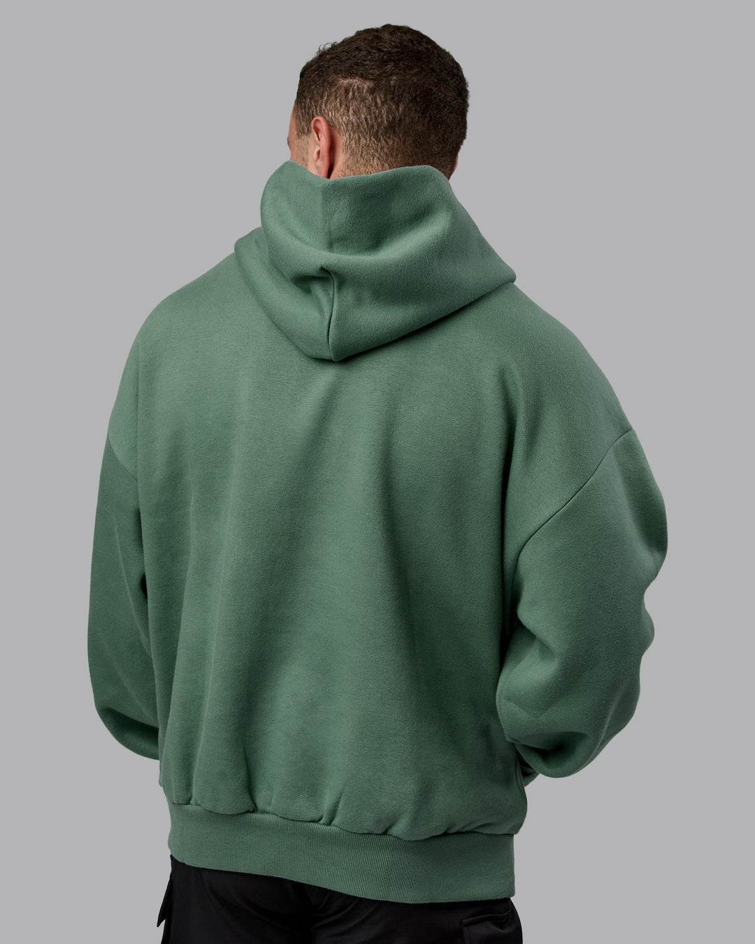 Man wearing Unisex MVP Hoodie Oversize - Sage Brush