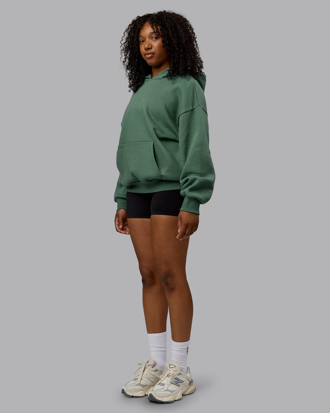 Woman wearing Unisex MVP Hoodie Oversize - Sage Brush