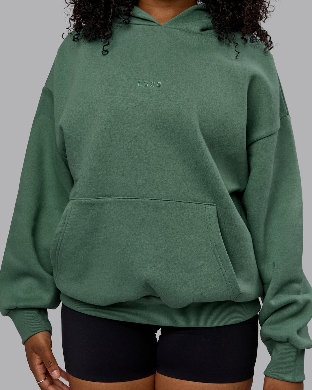 Woman wearing Unisex MVP Hoodie Oversize - Sage Brush