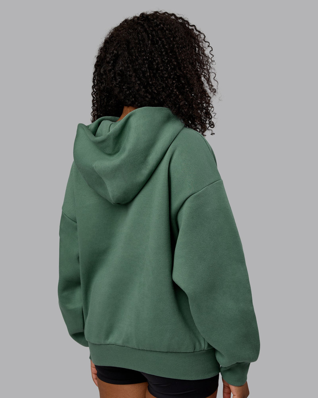 Woman wearing Unisex MVP Hoodie Oversize - Sage Brush