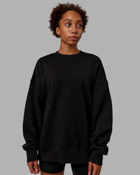 Woman wearing Unisex MVP Sweater Oversize - Black